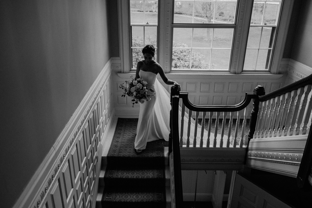 Bride going down staircase at The Lyman Estate Wedding