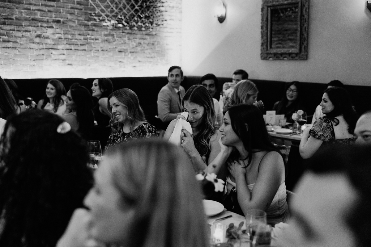 A lively gathering of friends enjoying an intimate moment at a dinner party, with laughter and smiles shared among the group.