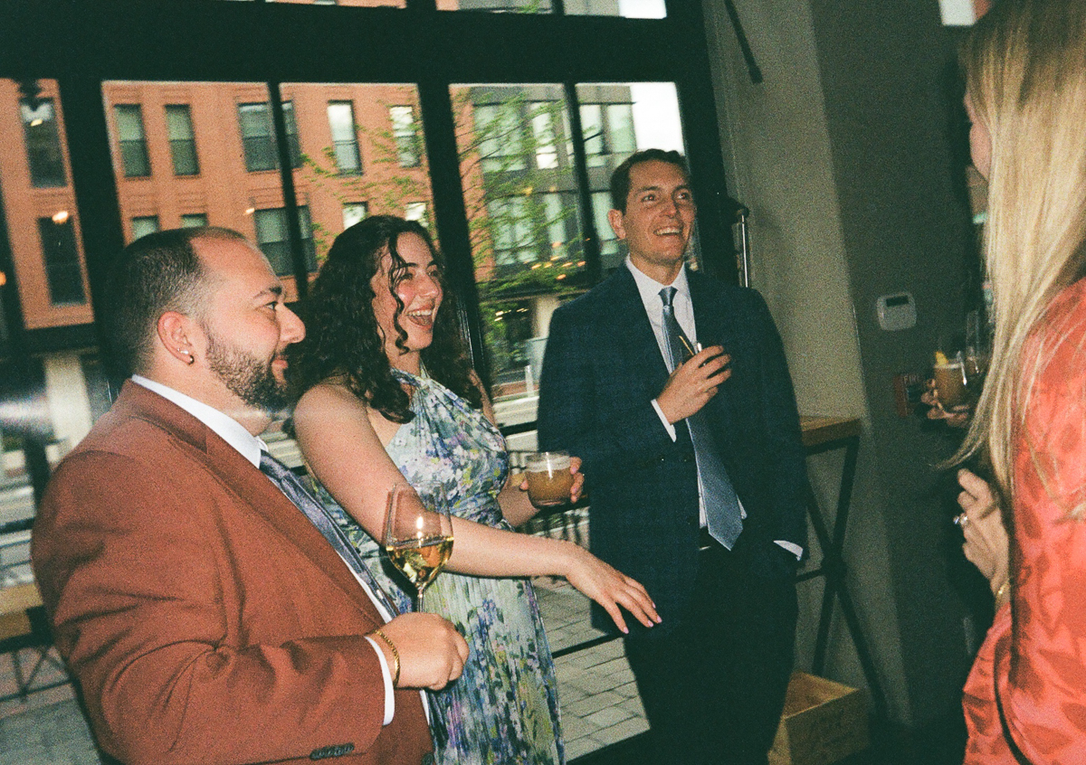 Group of friends enjoying a lively conversation and drinks at a social gathering.